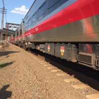 <p>Metro-North workers investigate the scene of a minor derailment Thursday afternoon in Rye.</p>