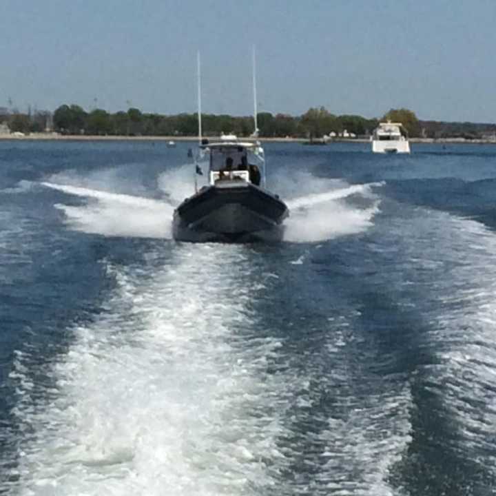 The Norwalk Police Marine Unit assists the Fairfield Police with its search for two missing men near Penfield Reef on Saturday.