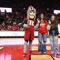 <p>Yadielis Gonzalez, center, being honored with the Rutgers Scarlet Knight mascot and her sister, Jossie.</p>