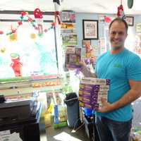 <p>Ken Maietta, owner of Tons of Toys, preps for holiday toy shoppers. Mom-and-pop stores like his, he says, have had to adapt to compete with online shopping and big-box stores.</p>