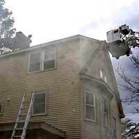 <p>Flames ran through the walls after igniting in the basement of the Maywood home on East Hunter Avenue.</p>