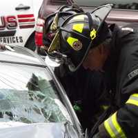 <p>Firefighters extricate the drivr,</p>