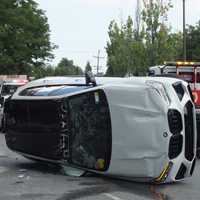 <p>All Points Towing rights the rolled BMW X5 SUV on Ann Court in Paramus.</p>