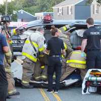 <p>Elmwood Park firefighters work to free the trapped and injured driver.</p>