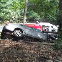 <p>Firefighters hooked a chain to stabilize the vehicle, which hung precariously on the side of the embankment off Route 208 in Hawthorne.</p>