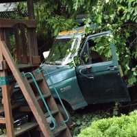Out-Of-Control Dump Truck Crashes Into Ridgewood Backyard Play Set