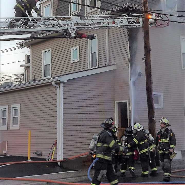 The two-alarm fire ignited on the exterior of the Godwin Avenue building that houses Custom Cut Salon before flames made their way inside.