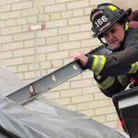 Ridgewood Firefighters Retrieve Loosened Metal Hanging Over Street