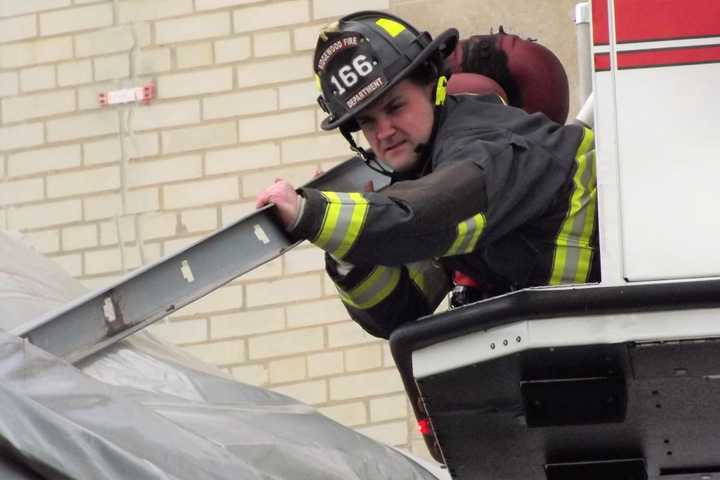 Ridgewood Firefighters Retrieve Loosened Metal Hanging Over Street