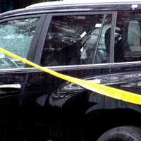 <p>Bergen County sheriff&#x27;s forensics investigators marked the spots where the Lexus parked in the Grove Street driveway in Waldwick was struck by gunfire.</p>