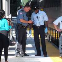 <p>Ridgewood police officer speaks with the conductor.</p>