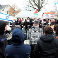 <p>The language got coarse at times, but metal barriers -- and lots of police officers, some in riot gear -- kept things cool in Teaneck on Sunday, March 10.</p>