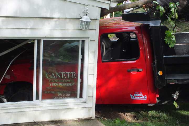 Dump Truck With Trailer Barrels Down Embankment Into Hawthorne Home