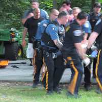 <p>Rescuers carry the man from the woods to a waiting ambulance in Paramus.</p>