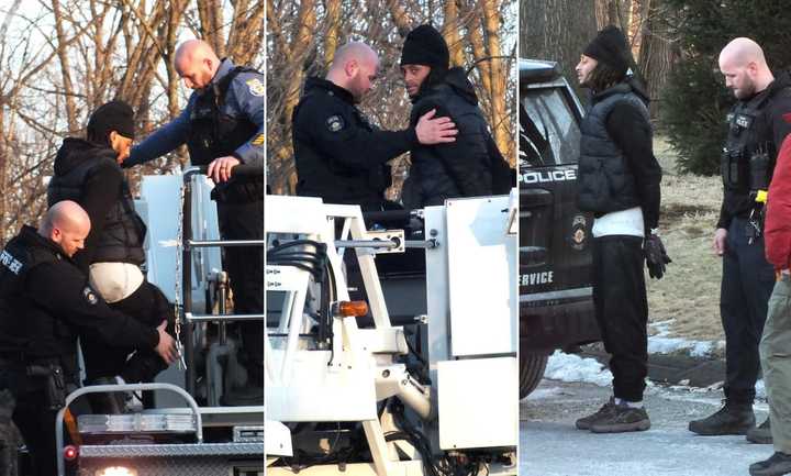 Paramus police remove one of the suspected car thieves from the roof of a business off Route 17.