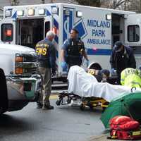 <p>EMS workers and police tend to one of the pedestrians struck in Wyckoff.</p>