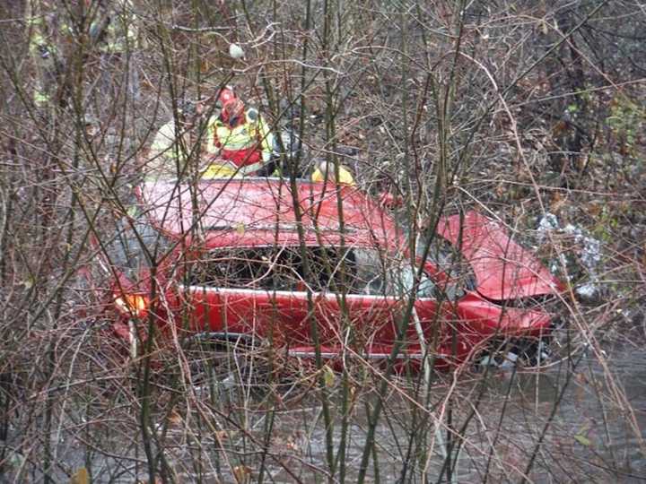 First-responders work to free a man from a Jeep after it crashed through a guardrail along Rt. 17 in Mahwah.