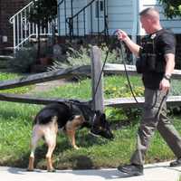 <p>A Bergen County K-9 leads investigators toward George Street in Fair Lawn following a bank robbery up the block Tuesday morning, July 11.</p>