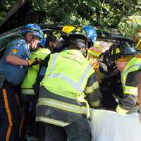 <p>Rescuers at work following the single-vehicle crash off Route 4 in Paramus on Wednesday, July 12.</p>