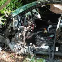 <p>The wreckage that was a Nissan Murano before it barreled off Route 4 and into a tree and guard rail in Paramus.</p>