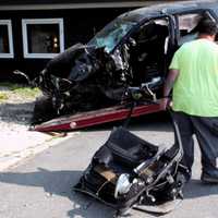 <p>Tow truck driver drags a hunk of what once was a vehicle.</p>