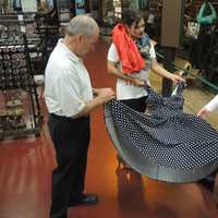 <p>Profession William Filerino, Palenia Pichardo and Cristina Deutsch show off a dress at the Paterson Museum.</p>