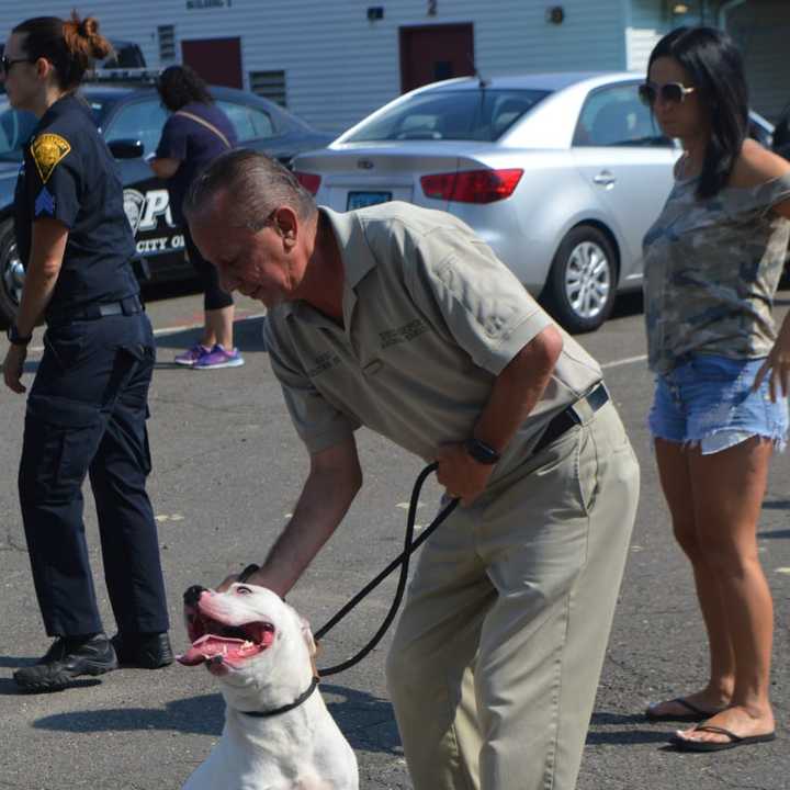 Bridgeport Animal Control celebrates the groundbreaking of three new outdoor play spaces with staff member Eric Cubero and Diesel.