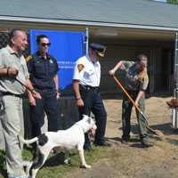 <p>Chief Animal Control Officer Jennifer Wallace breaks ground on the new dog play spaces at Bridgeport Animal Control, while Police Chief AJ Perez, third from left, and Mayor Joe Ganim, second from right, look on.</p>