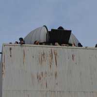 <p>Eclipse fans crowded the terrace atop the Rolnick Observatory in Westport.</p>