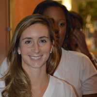 <p>Carolyn Carino walks into the Pepsico Theatre to receive her nursing pin during a ceremony at Norwalk Community College Wednesday. </p>