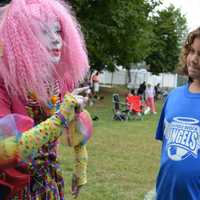 <p>Therapy Clown Dipsy Doodle introduces herself to Samantha Maniscalco and a friend she met on the field.</p>