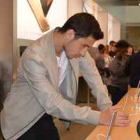 <p>A shopper checks out new technology in the Apple Store in Paramus.</p>