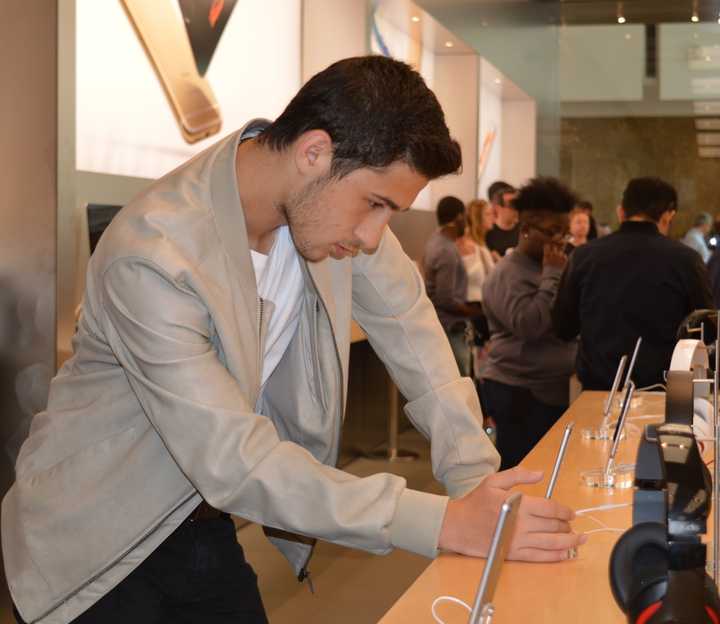 A shopper checks out new technology in the Apple Store in Paramus.