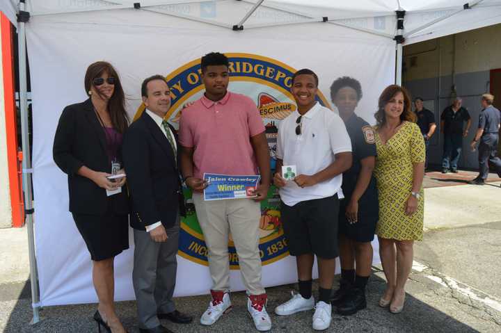 Mayor Joe Ganim, second from left, presents Jalen Crawley, center, with his new iPod Shuffle.