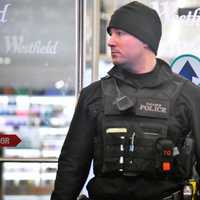 <p>A Paramus police officer stands guard following Saturday night&#x27;s incident at the Garden State Plaza.</p>