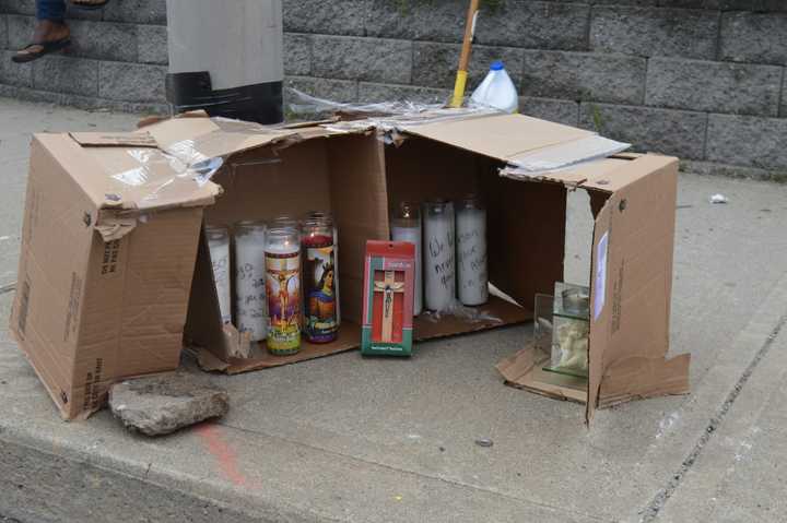 A makeshift memorial remained Wednesday at the site of a police officer-involved fatal shooting in Bridgeport.