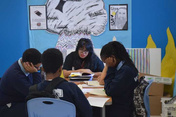 Students at Great Oaks Charter School work in small groups to boost their reading and comprehension skills.