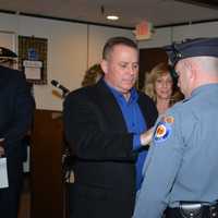 <p>Retired Paramus Police Sergeant Glenn Doughty. pins his son, Brian Doughty.</p>