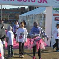 <p>Participants in the kids fun run cross the finish line before the start of the 2016 Vicki Soto 5K in Stratford.</p>