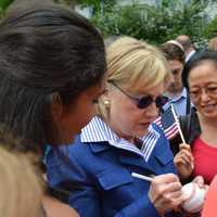 <p>Hillary Clinton autographs a baseball while meeting community members prior to the start of New Castle&#x27;s 2016 Memorial Day parade.</p>