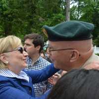 <p>Hillary Clinton embraces Jim McCauley, a local resident and Vietnam War veteran who has served as emcee for the Memorial Day parade for years. McCauley, who is active in local Republican politics, has a friendly relationship with Clinton.</p>