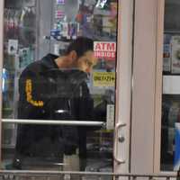 <p>A member of the Bergen County Sheriff&#x27;s Bureau of Criminal Identification collects evidence following the Sunday, March 19 robbery of the Sunoco station on Polifly Road in Hackensack.</p>