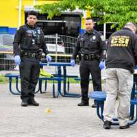 <p>The area at the bus stop on Main Avenue at Burgless Place in Passaic was cordoned off while a forensic investigator collected evidence.</p>