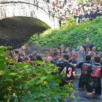 <p>Rye players celebrate their win by jumping in the creek, after beating Harrison.</p>