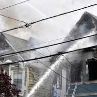 <p>The fast-moving blaze Tuesday afternoon on Knickerbocker Avenue ravaged one home and severely damaged another.</p>