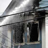 <p>The fire apparently ignited on the second floor and shot through the upper-floor windows of one of the various wood-frame, multi-family homes on Knickerbocker Avenue in Paterson.</p>