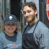 <p>Maycie Maringer and Sam Ralbovsky pose in front of the Nosh Hound food truck in Stamford Tuesday. Ralbovsky is a Stamford native.</p>