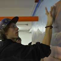 <p>Nicholas Schleissmann provides some touches to a new mural in the children&#x27;s studio at the Katonah Art Center&#x27;s new home in Goldens Bridge.</p>