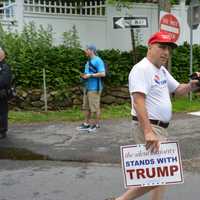 <p>A supporter of Donald Trump, the Republican Party&#x27;s presumptive presidential nominee, makes his presence known a short distance away from Hillary Clinton prior to the start of New Castle&#x27;s Memorial Day parade.</p>