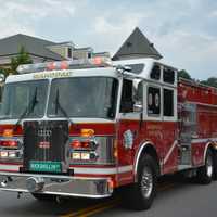 <p>A Mahopac firetruck is driven through the fire department&#x27;s dress parade.</p>